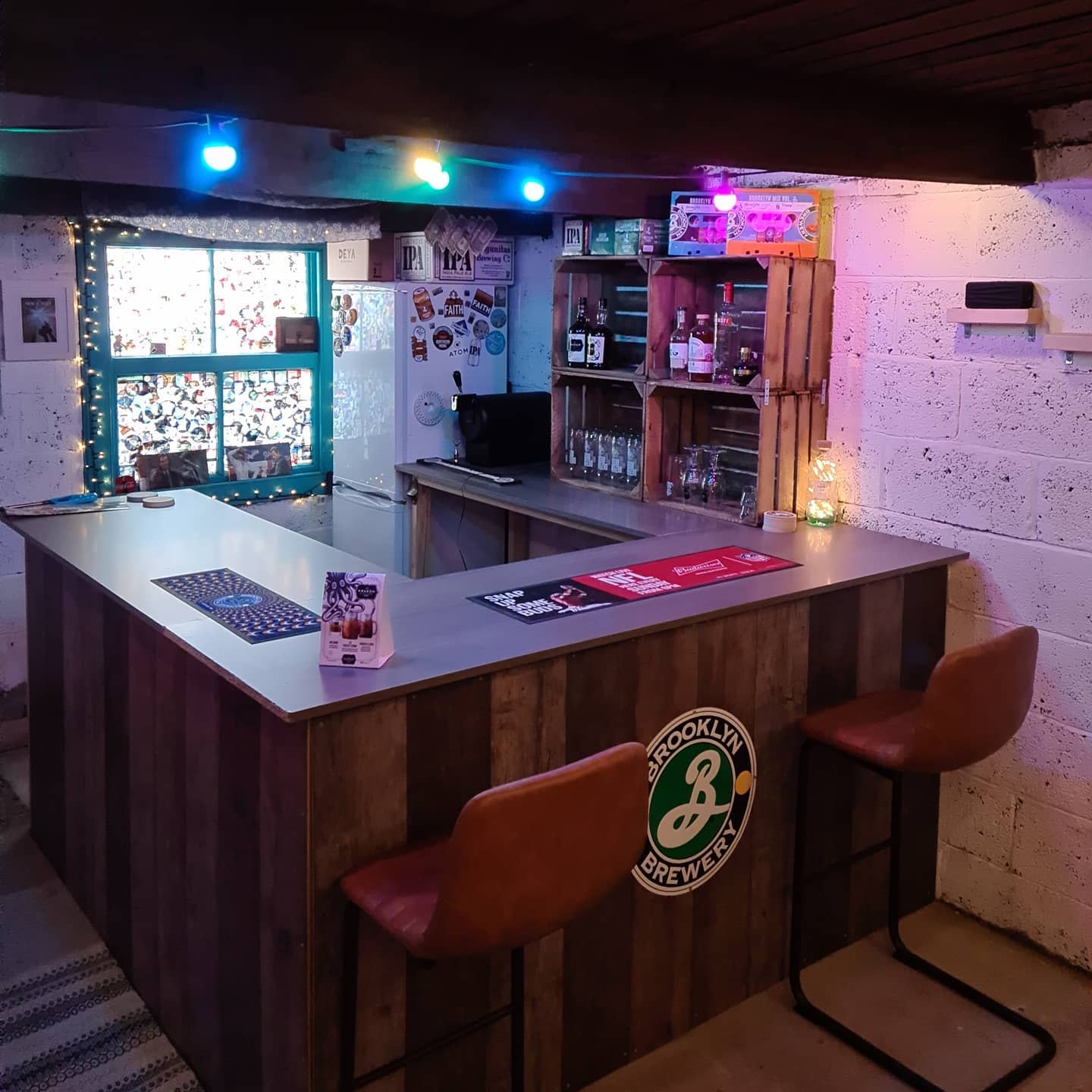 wood garage bar fairy lights wood crate storage white brick wall